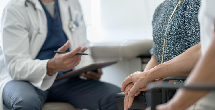 A generic photograph of people in a medical consulting room